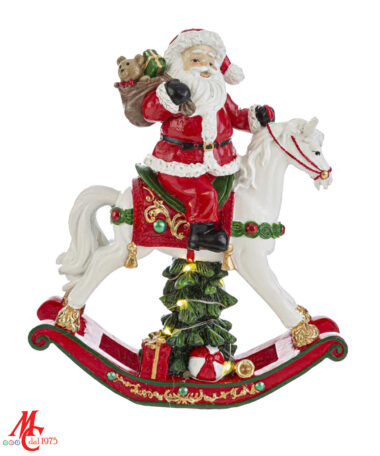 Babbo Natale su Cavalluccio a dondolo Materiale: Resina - Misure: 15cm × 4,5cm x h.18cm Colore: Bianco - Rosso - Verde